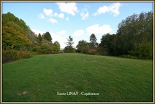 Domaine paysager reconnu avec parc floral, batiments et terres agricoles