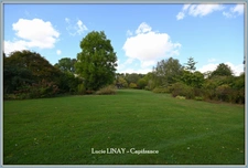 Domaine paysager reconnu avec parc floral, batiments et terres agricoles