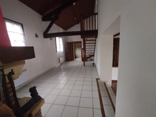 Maison à trois chambres avec un double garage située dans un environnement boisé sans voisins.