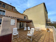 Maison de village avec garage et terrasse.