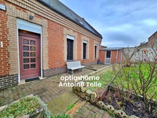Le Cateau - Maison semi-individuelle à double accès avec garage, devanture & jardin clos sur 960m².