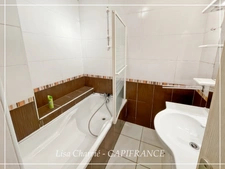 Townhouse for sale in Vic-Fezensac (32), divided into 2 rented apartments, with terrace, balcony, and garage.