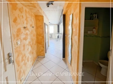 Townhouse for sale in Vic-Fezensac (32), divided into 2 rented apartments, with terrace, balcony, and garage.
