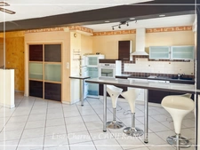 Townhouse for sale in Vic-Fezensac (32), divided into 2 rented apartments, with terrace, balcony, and garage.