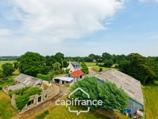 PROPERTY COMPRISING A HOUSE, A 360 M² SHED, NUMEROUS OUTBUILDINGS AND 6,280 M² OF LAND – SET IN NATURAL SURROUNDINGS IN KERFOURN, NEAR PONTIVY